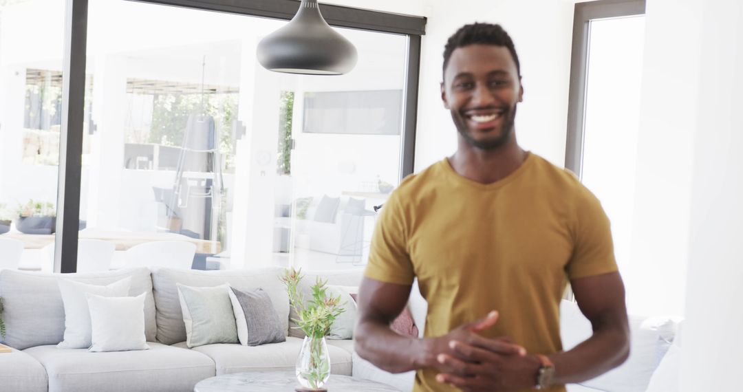 Cheerful Man in Modern Living Room with Contemporary Décor - Free Images, Stock Photos and Pictures on Pikwizard.com