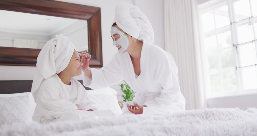 Mother and Daughter Enjoying Spa Day with Face Masks and Towels on Heads - Free Images, Stock Photos and Pictures on Pikwizard.com