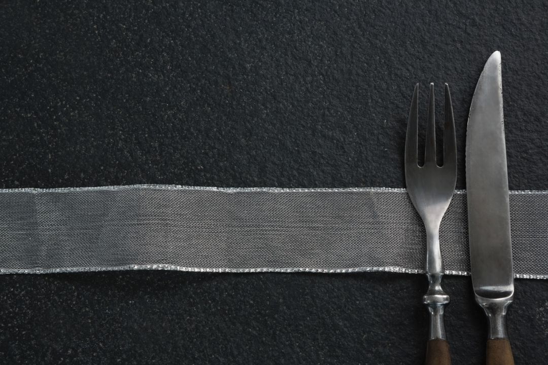 Elegant Fork and Knife on Black Slate Background - Free Images, Stock Photos and Pictures on Pikwizard.com
