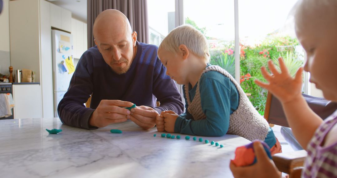 Father Engaging with Children in Creative Activity at Home