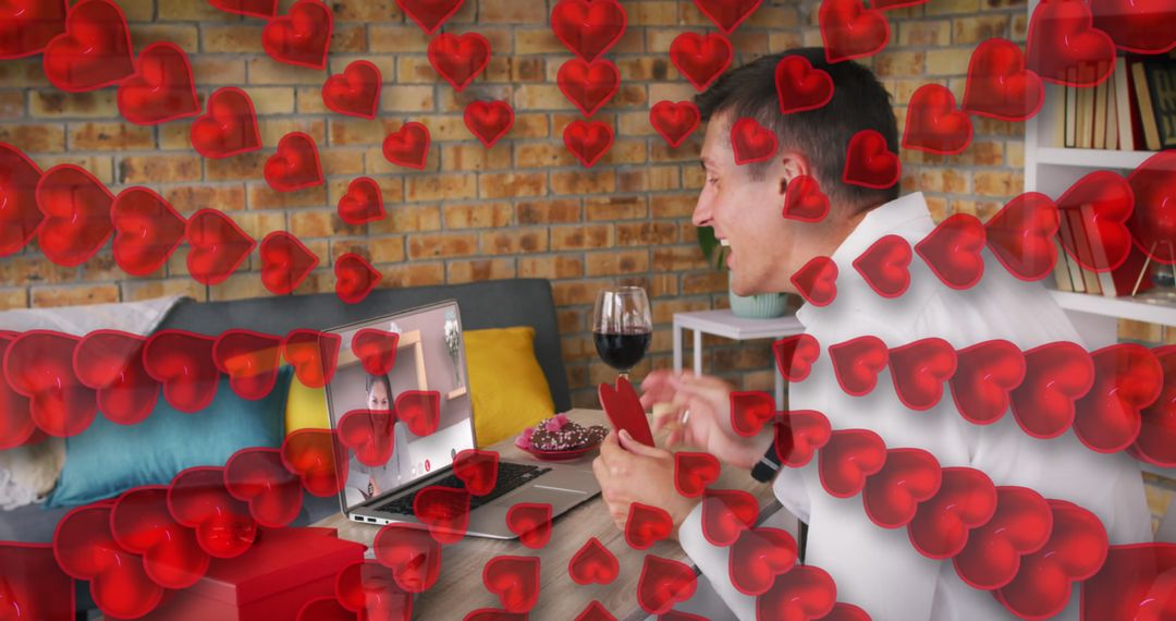 Man Enjoying Romantic Virtual Date Surrounded by Hearts