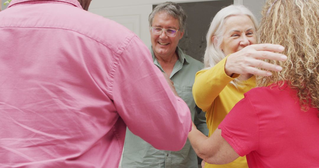 Image of happy caucasian senior couple welcoming friends - Free Images, Stock Photos and Pictures on Pikwizard.com