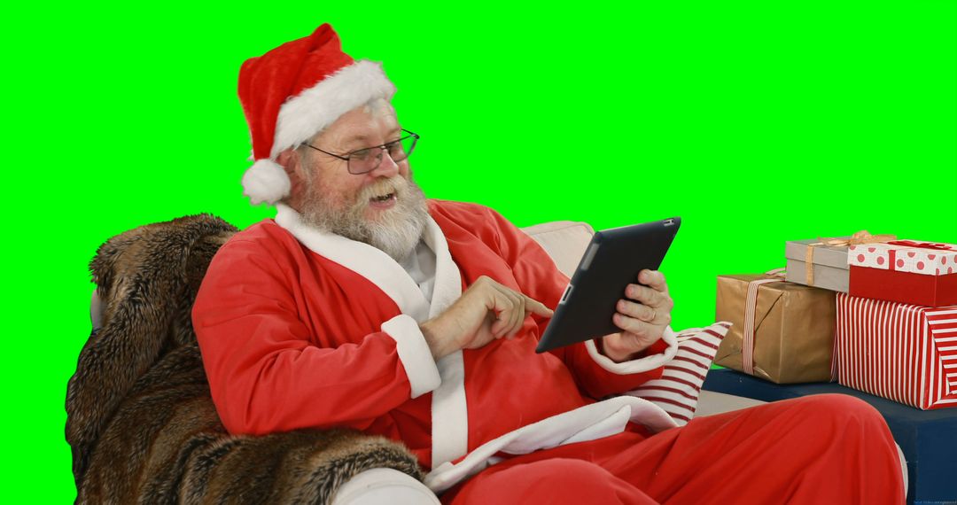 Santa Claus Relaxing with Digital Tablet - Free Images, Stock Photos and Pictures on Pikwizard.com