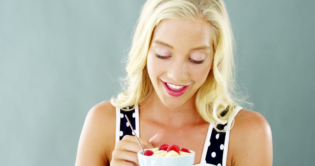 Smiling Woman Enjoying Healthy Breakfast with Berries and Yogurt - Free Images, Stock Photos and Pictures on Pikwizard.com