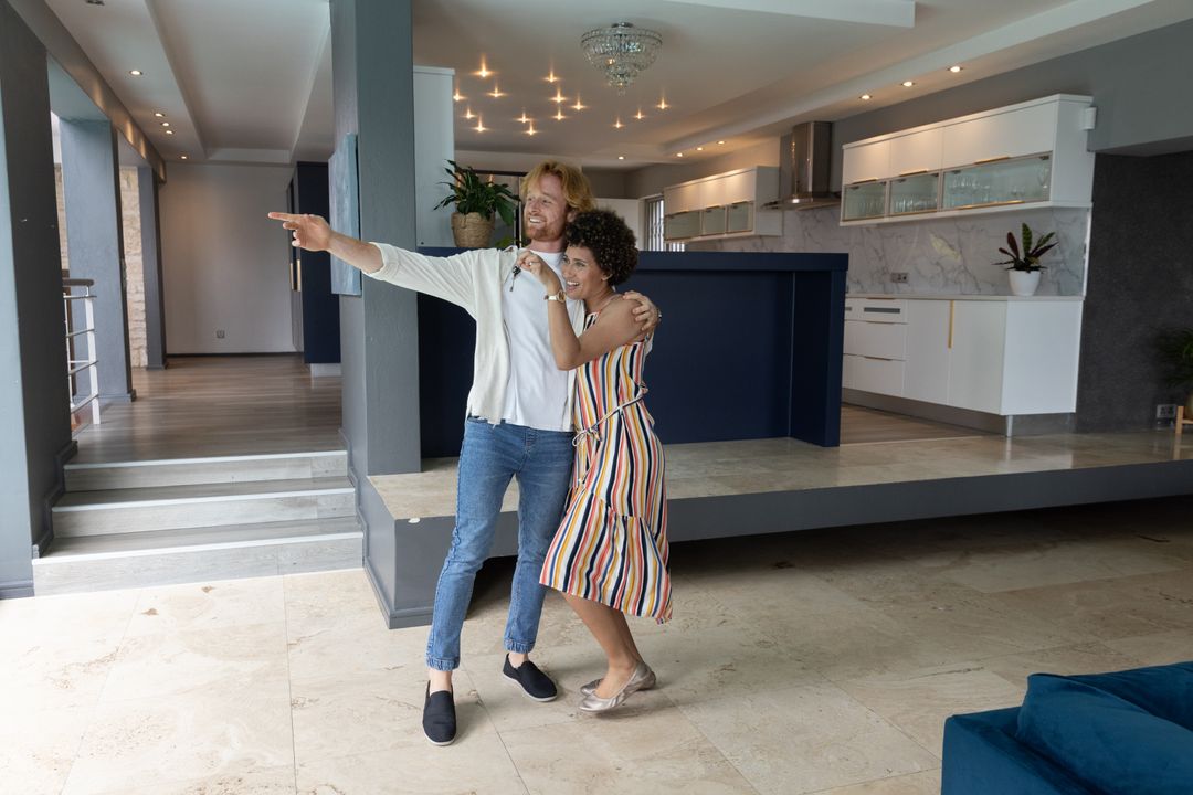 Diverse Couple Embracing in Luxurious Open-Plan Home