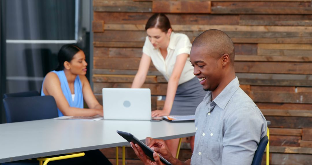 Smiling Businessman Browsing Tablet in Modern Office
