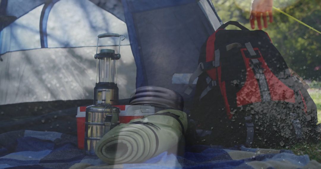 Camping Essentials at Tent Entrance Including Lantern and Gear