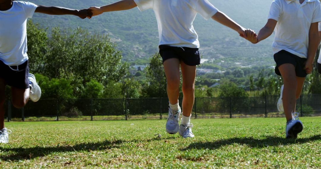 Children Holding Hands Running on Field - Free Images, Stock Photos and Pictures on Pikwizard.com