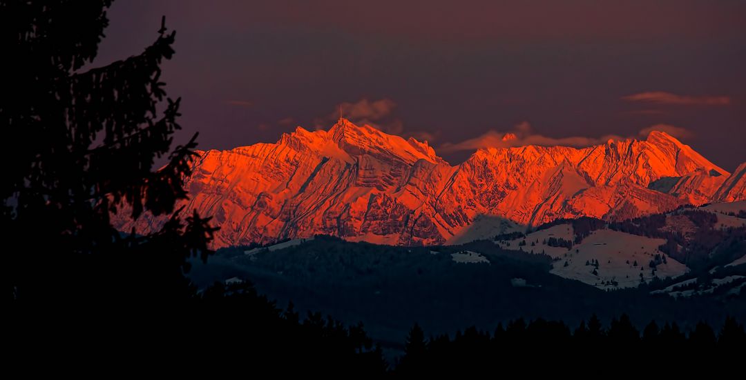 Sunset Illuminates Snow-Capped Mountain Peaks with Warm Red Light - Free Images, Stock Photos and Pictures on Pikwizard.com