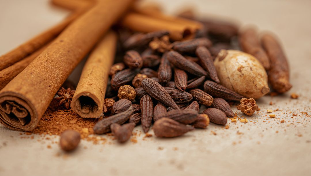 Warm spice mix with cinnamon sticks, cloves and star anise closeup macro still life