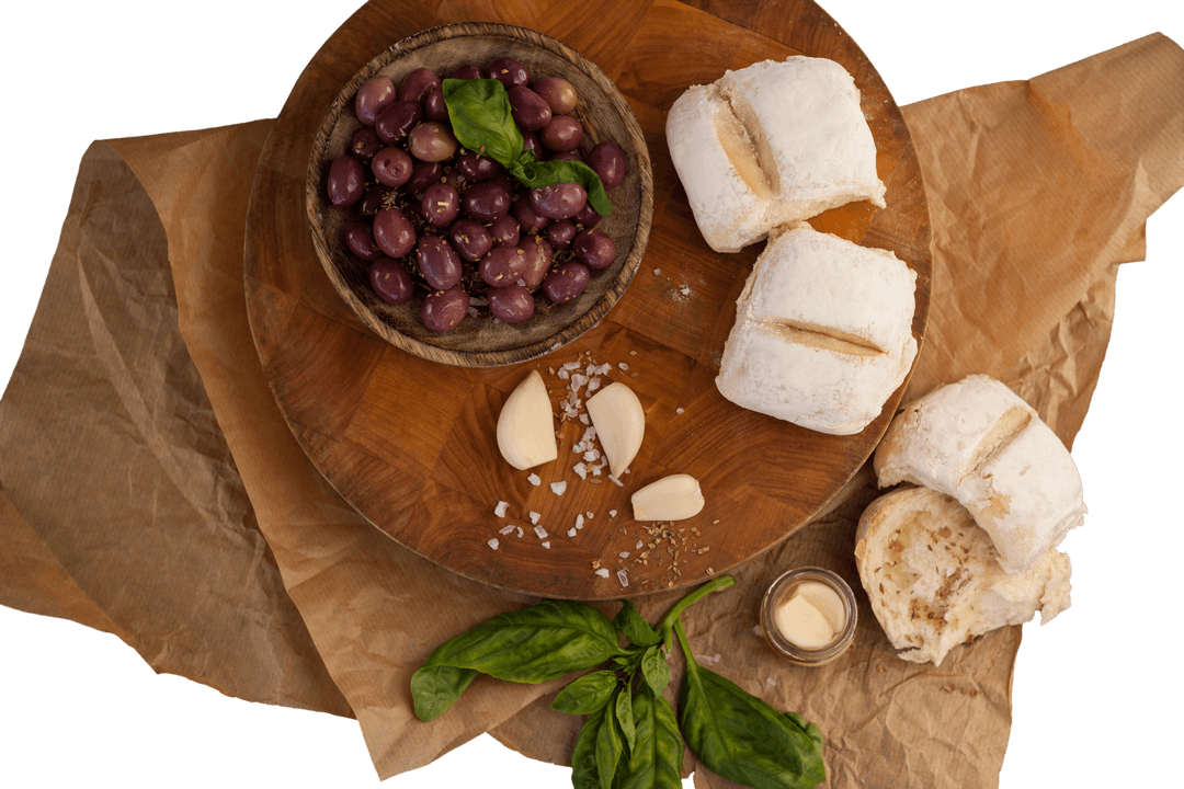 Transparent Cutting Board with Black Olives and Artisan Bread Arrangement