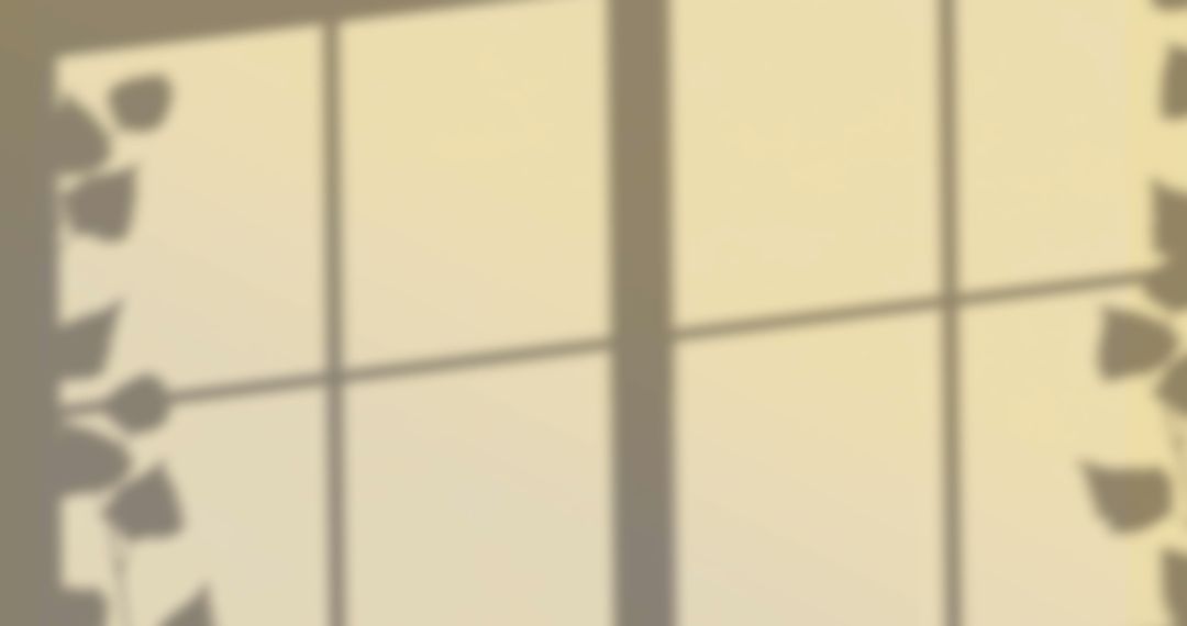 Leaf Shadows Casting on Soft Yellow Background