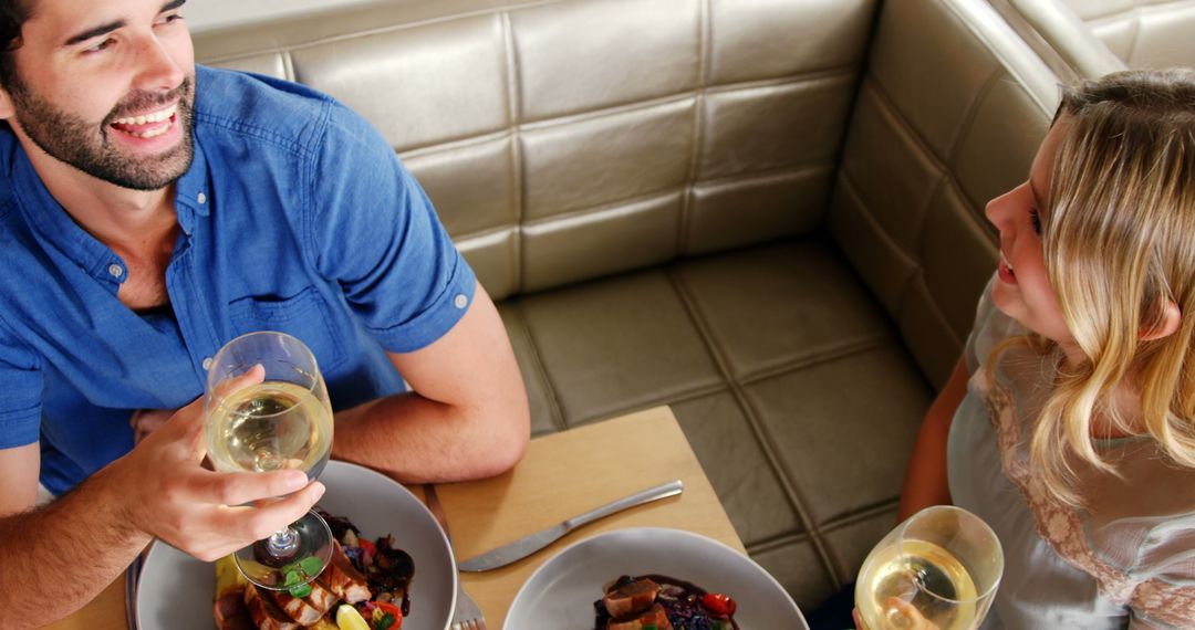 Young couple enjoying romantic dinner in restaurant