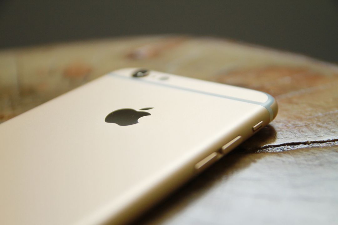 Close-Up of Gold Smartphone on Wooden Surface in Soft Light - Free Images, Stock Photos and Pictures on Pikwizard.com