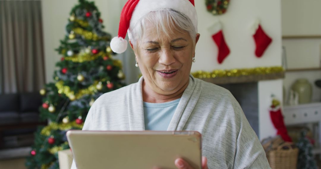 Senior Woman Using Tablet During Christmas, Virtual Family Connection - Free Images, Stock Photos and Pictures on Pikwizard.com