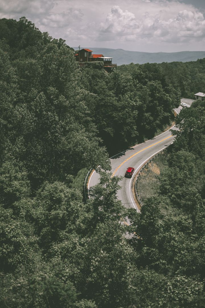 Red Car Driving on Winding Mountain Road - Free Images, Stock Photos and Pictures on Pikwizard.com