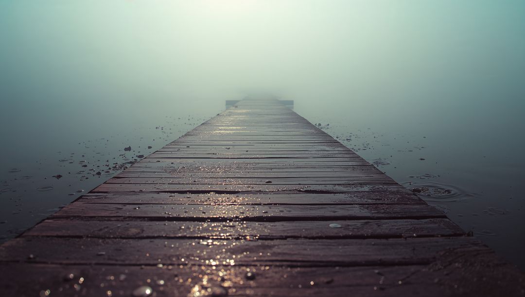 Weathered Dock Extending into Misty Lakeshore