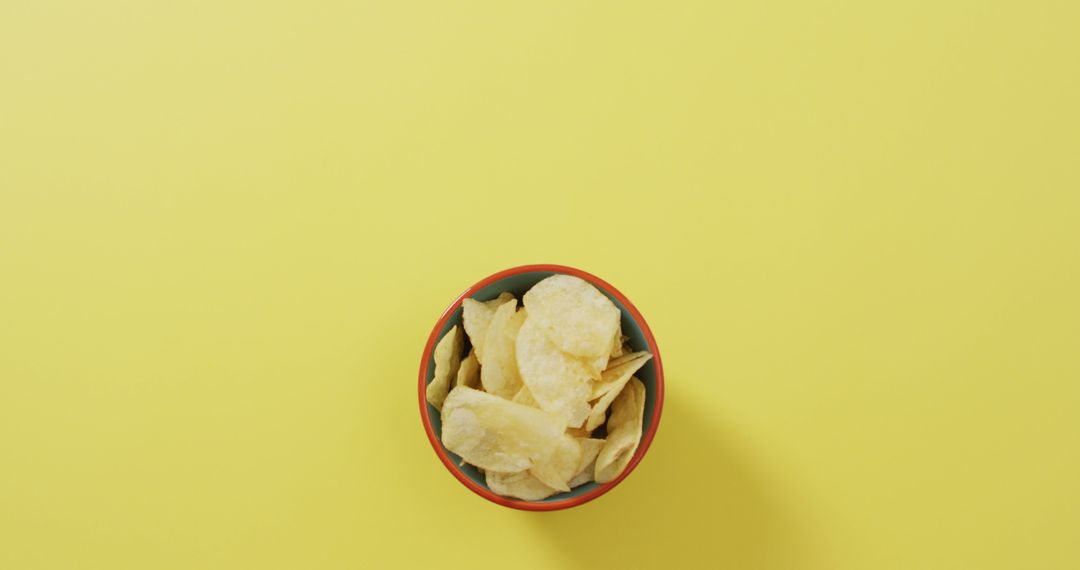 Potato Chips in Blue Bowl on Yellow Background - Free Images, Stock Photos and Pictures on Pikwizard.com