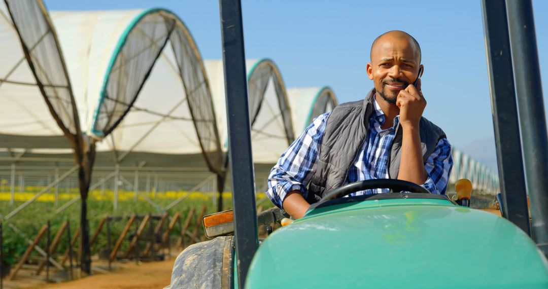 Smiling Farmer Talking on Smartphone While Driving Tractor - Free Images, Stock Photos and Pictures on Pikwizard.com