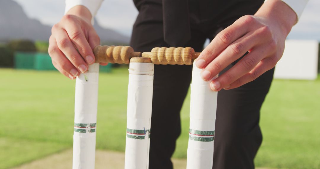 Cricketer Setting Up Stumps on Cricket Field Before Match - Free Images, Stock Photos and Pictures on Pikwizard.com