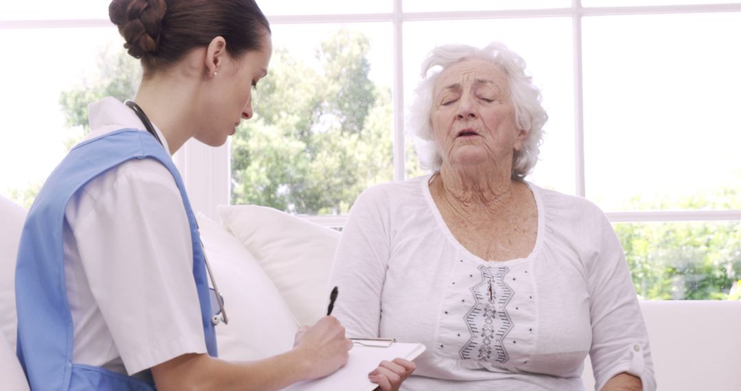 Elderly Woman Receiving Medical Consultation from Nurse - Free Images, Stock Photos and Pictures on Pikwizard.com