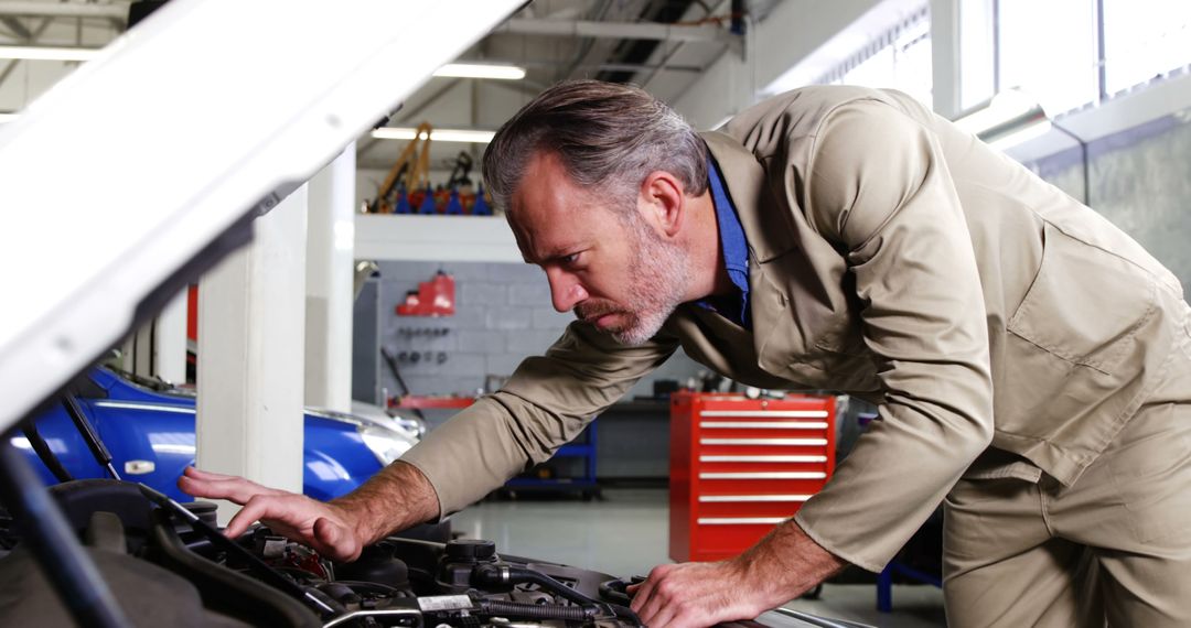 Experienced Mechanic Fixing Car Engine in Workshop Garage - Free Images, Stock Photos and Pictures on Pikwizard.com