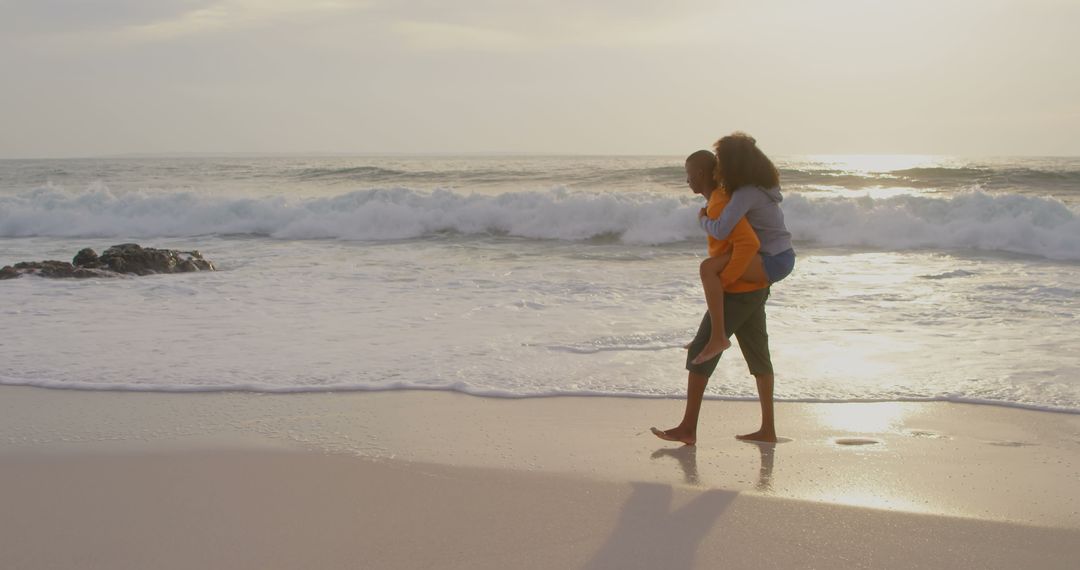 Couple Enjoying Playful Piggyback Ride on Serene Beach