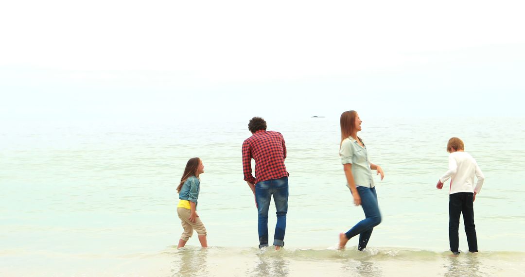 Family looking at the beach together - Free Images, Stock Photos and Pictures on Pikwizard.com