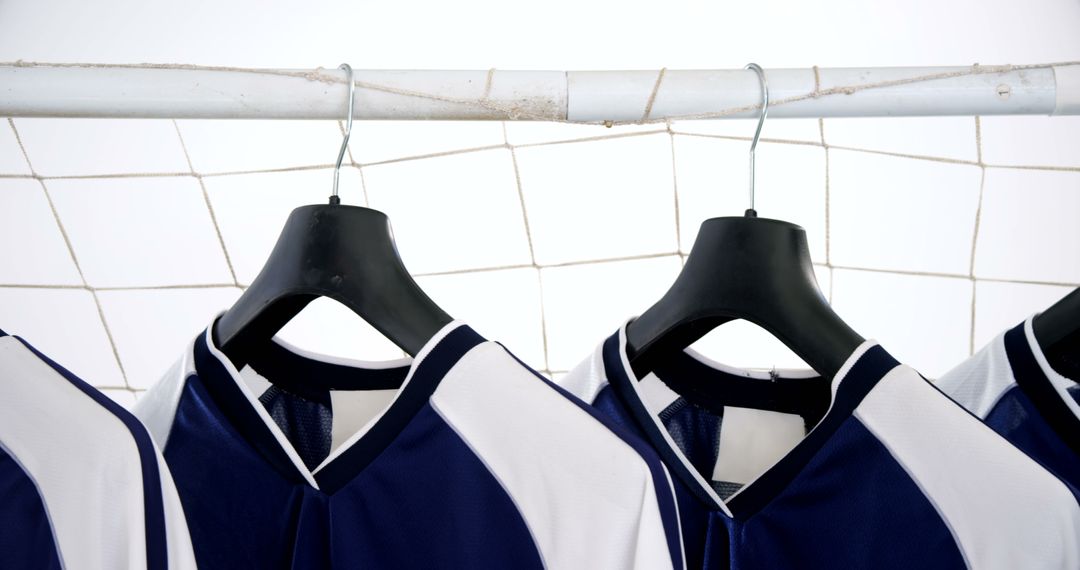 Blue and White Soccer Jerseys Hanging on Goal Post - Free Images, Stock Photos and Pictures on Pikwizard.com