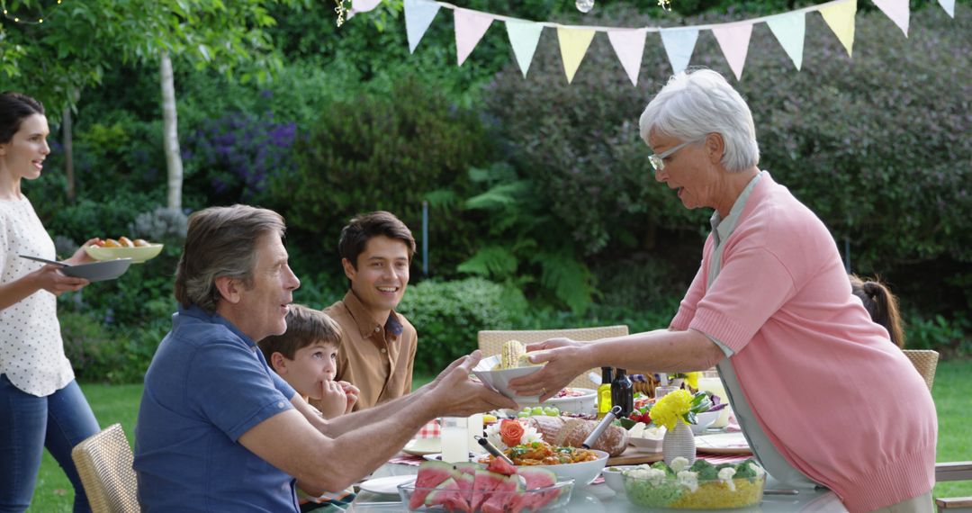 Multigenerational Family Enjoying Outdoor Celebration Meal - Free Images, Stock Photos and Pictures on Pikwizard.com