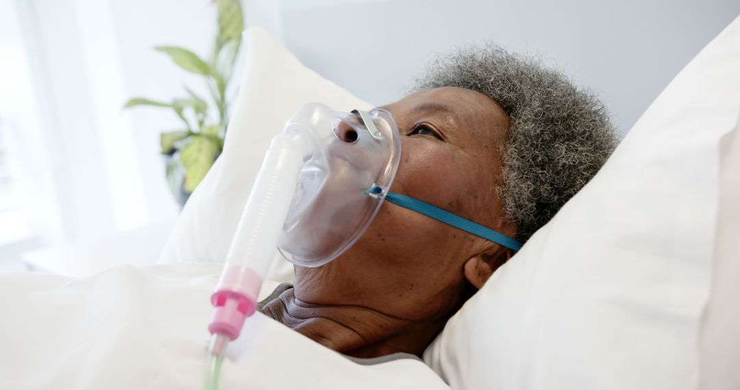 Elderly Patient Receiving Oxygen Therapy in Hospital Bed - Free Images, Stock Photos and Pictures on Pikwizard.com