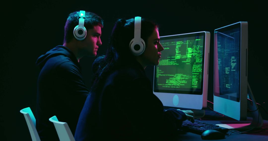 Focused Programmers Using Dual Screens with Headphones
