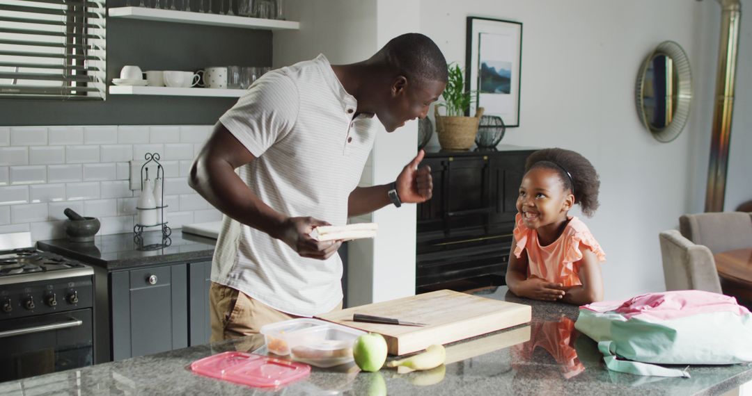 Image of african american father and daughter preparing breakfast - Free Images, Stock Photos and Pictures on Pikwizard.com