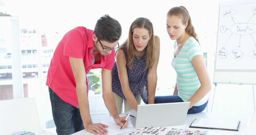 Creative Professionals Collaborating in Bright Workspace