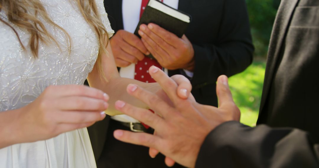 Bride placing ring on groom's finger during wedding ceremony - Free Images, Stock Photos and Pictures on Pikwizard.com