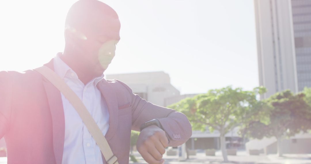 Businessman in Urban Setting Checking Time on Smartwatch