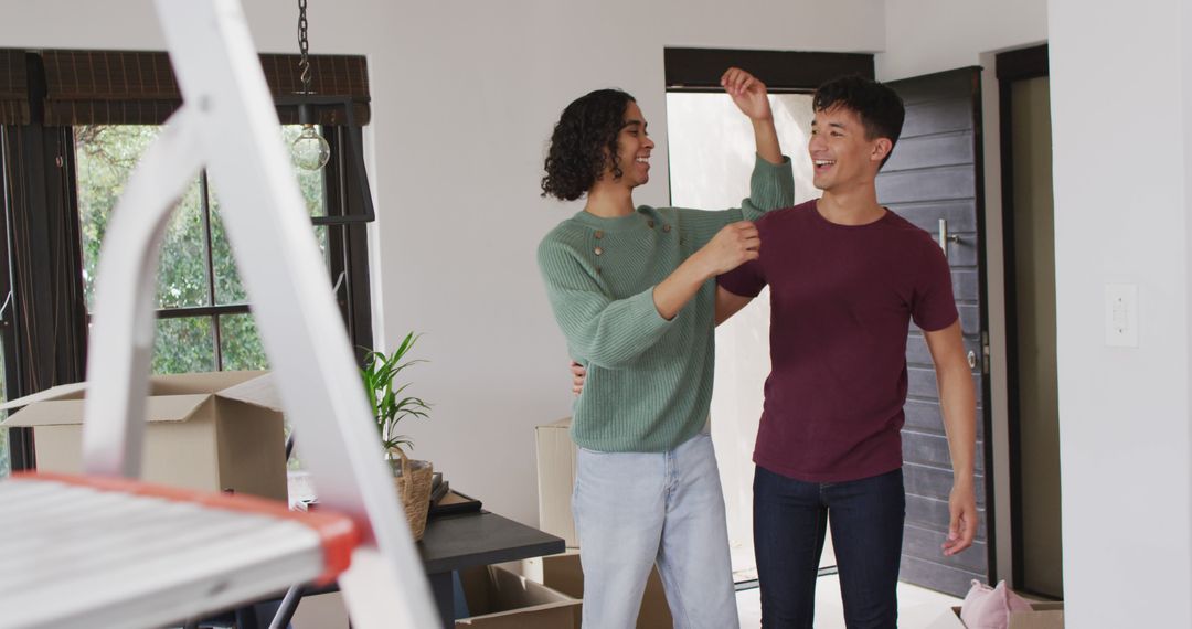 Happy Diverse Couple Embracing and Moving into New Home