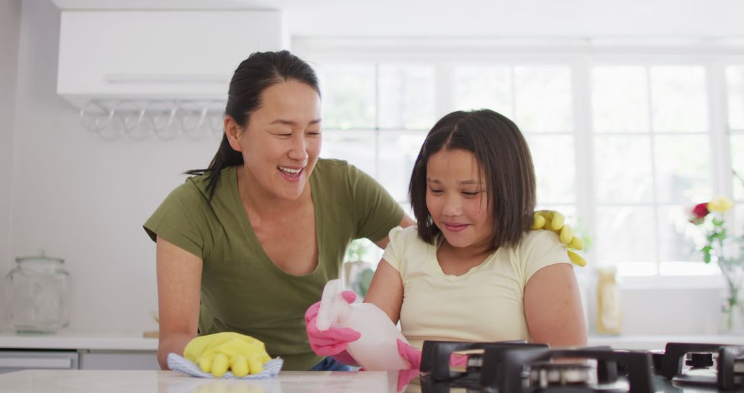 Image of happy asian mother and daughter cleaning kitchen - Free Images, Stock Photos and Pictures on Pikwizard.com