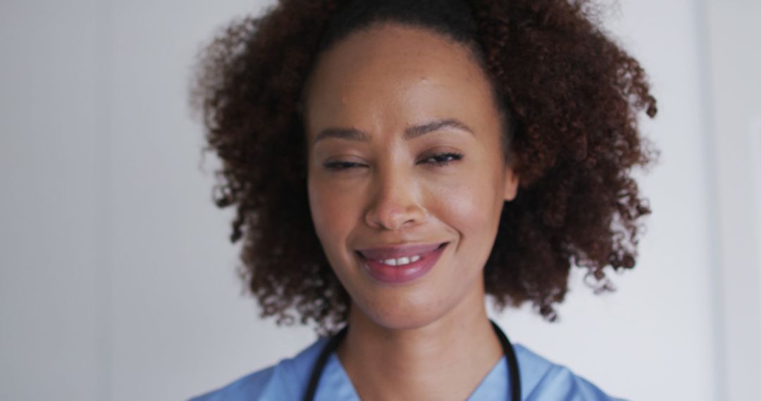 Smiling Female Doctor Winking at Camera with Stethoscope, Personal Connection in Healthcare - Free Images, Stock Photos and Pictures on Pikwizard.com