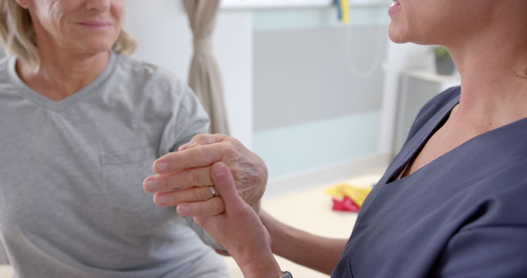 Healthcare Practitioner Assisting Senior Patient with Hand Therapy - Free Images, Stock Photos and Pictures on Pikwizard.com