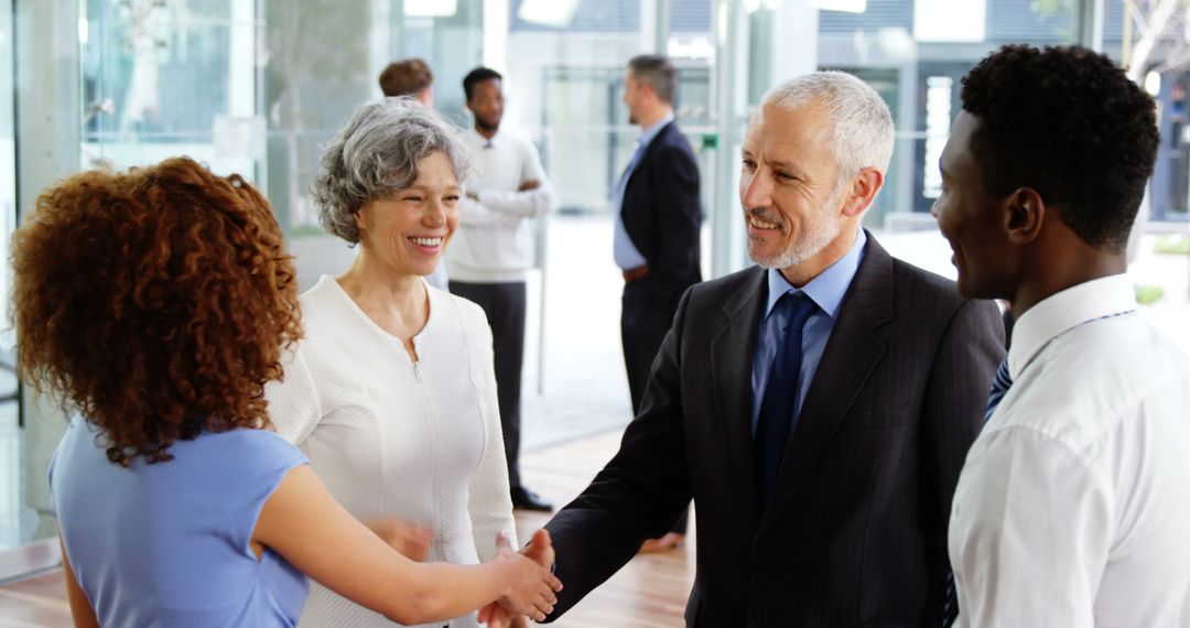 Business Professionals Shaking Hands in Office Setting