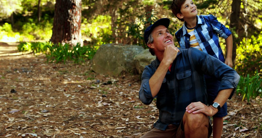 Father and Son Observing Nature in Forest - Free Images, Stock Photos and Pictures on Pikwizard.com