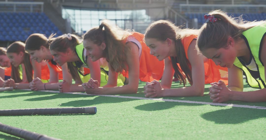 Teen Girls Performing Plank Exercise on Sports Field - Free Images, Stock Photos and Pictures on Pikwizard.com