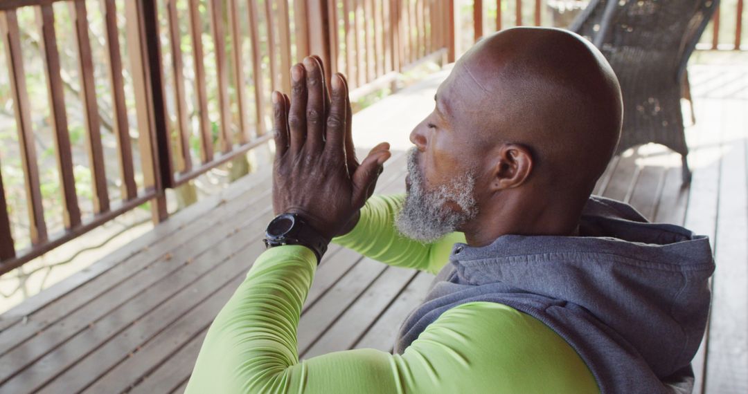 Senior African-American Man Meditating on Outdoor Deck - Free Images, Stock Photos and Pictures on Pikwizard.com