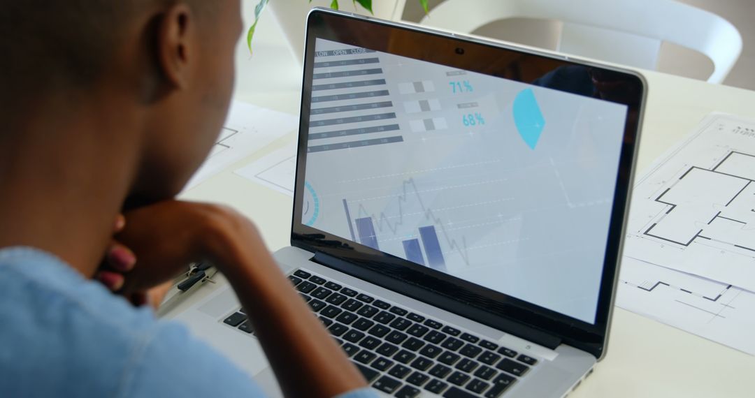Focused Businesswoman Analyzing Data on Laptop Screen