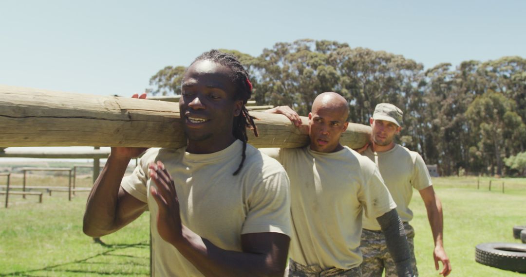 Fit Soldiers Training with Log in Outdoor Boot Camp