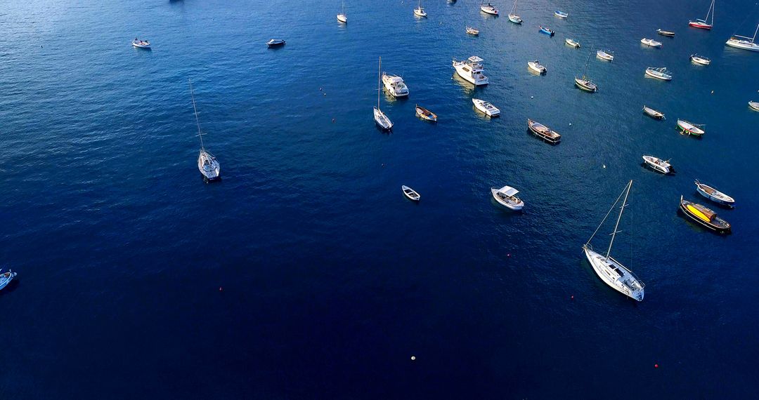 Aerial View of Multiple Boats Anchored on Calm Blue Waters - Free Images, Stock Photos and Pictures on Pikwizard.com