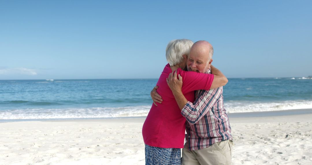 Happy Senior Couple Embracing on Sandy Beach on Sunny Day - Free Images, Stock Photos and Pictures on Pikwizard.com