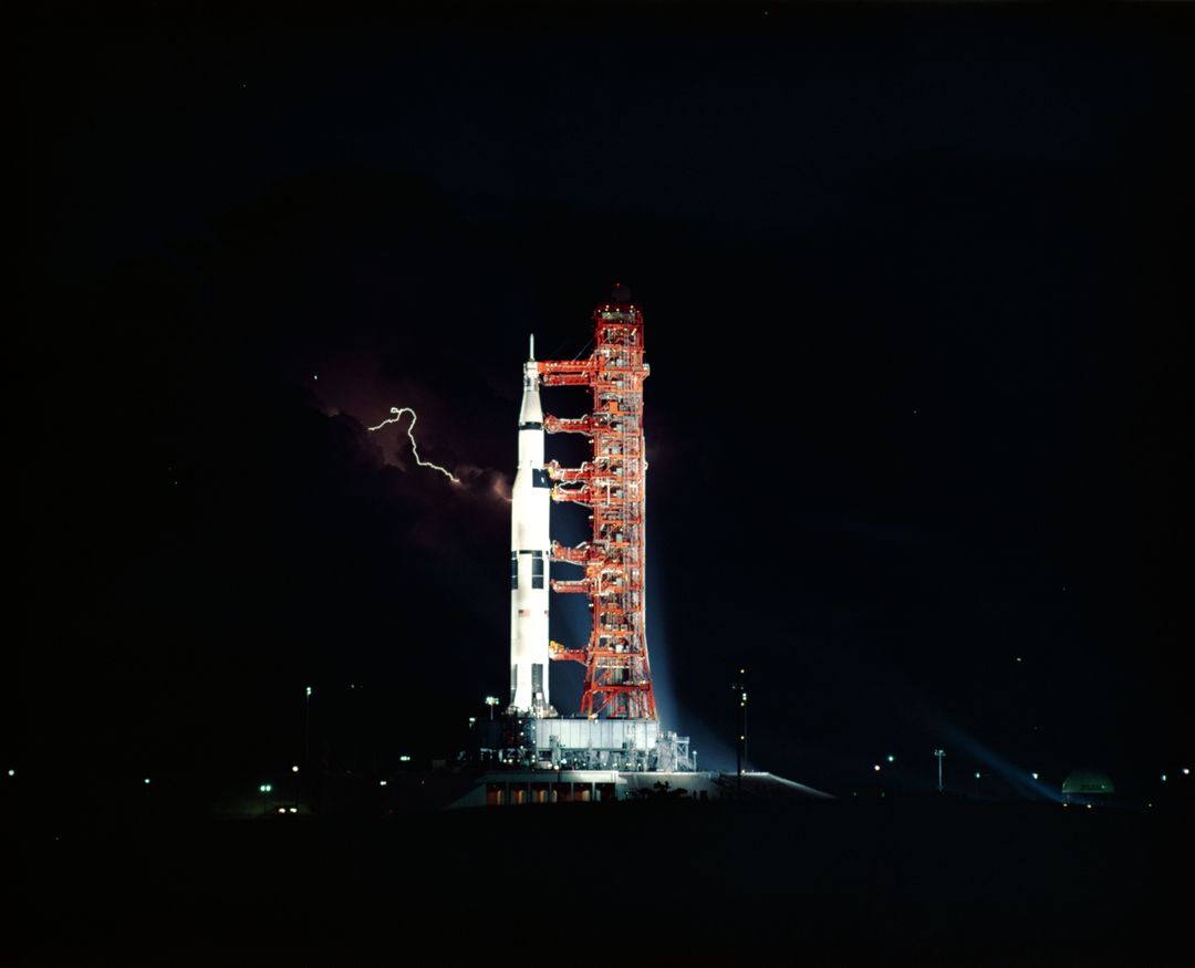 Apollo 15 Saturn V Rocket at Night with Lightning in Background, July 1971 - Free Images, Stock Photos and Pictures on Pikwizard.com