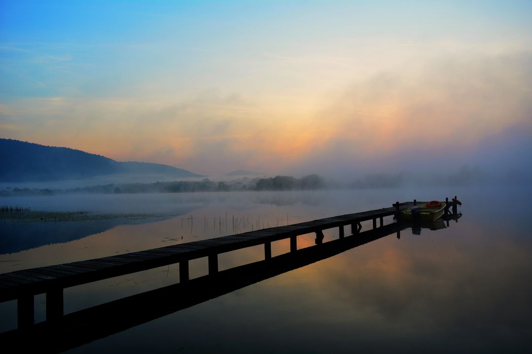 Tranquil pier at sunrise with mist over lake - Free Images, Stock Photos and Pictures on Pikwizard.com